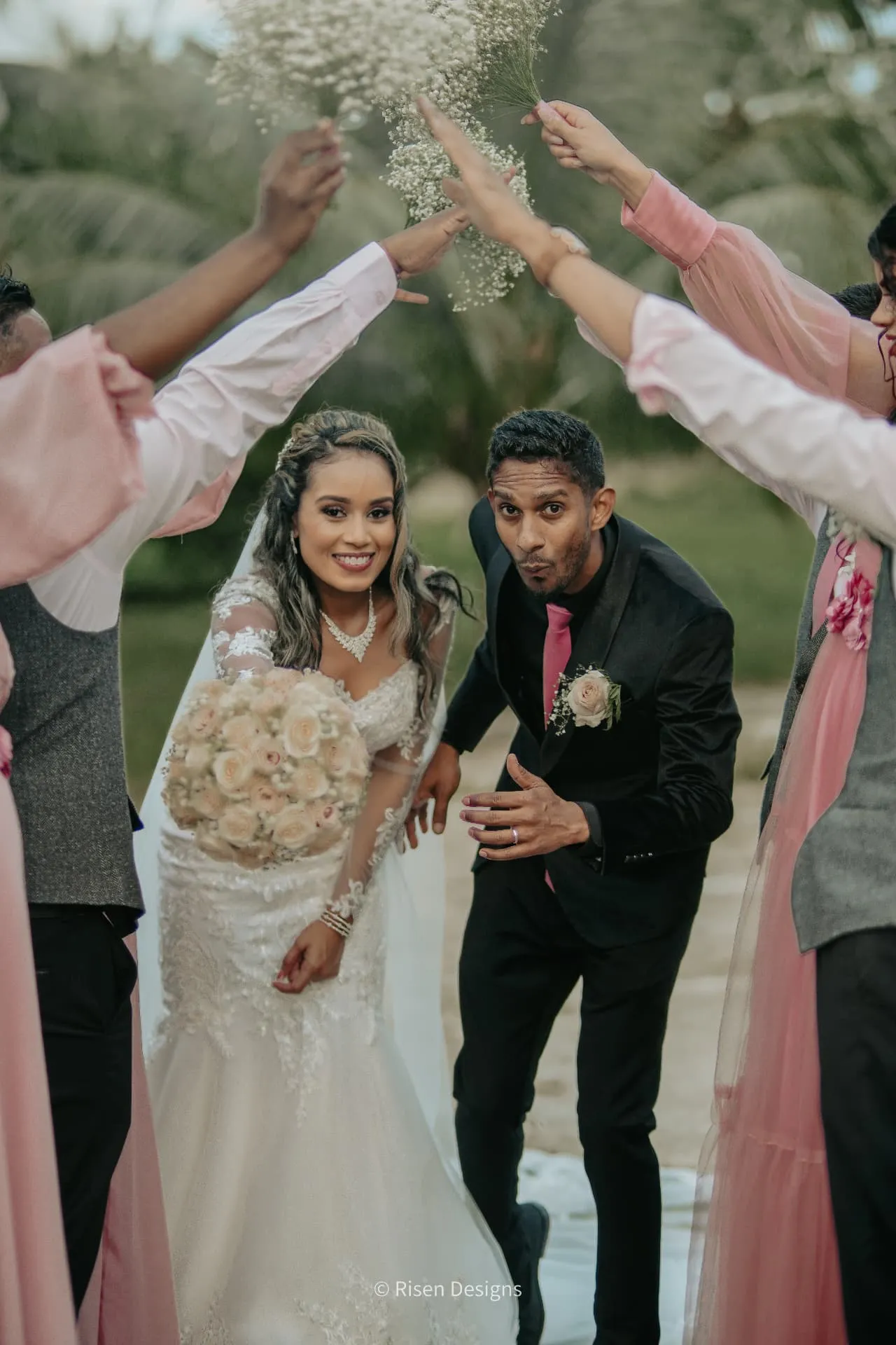 Timothy & Keziah — Through the arch of bouquets